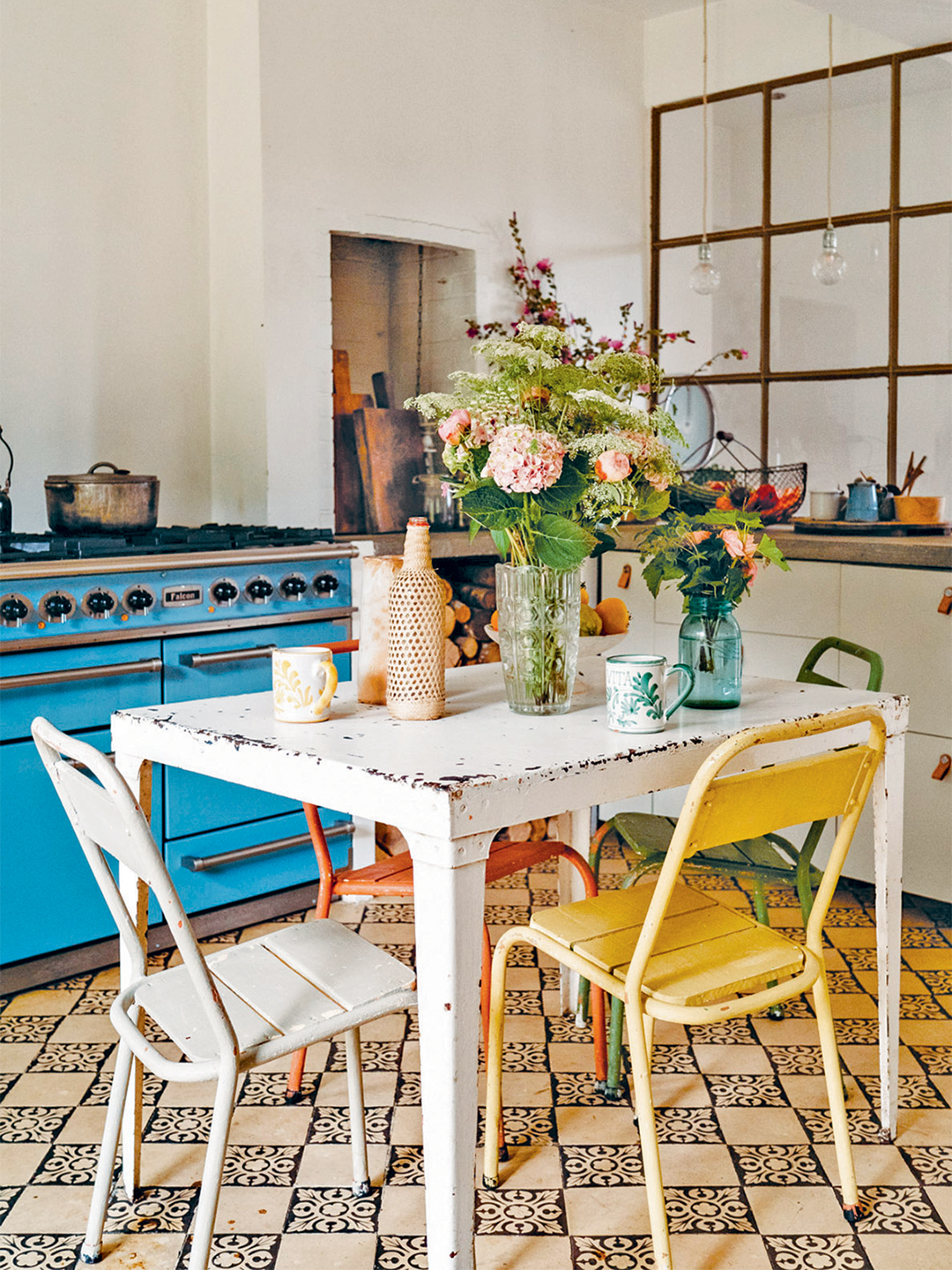 Vintage kitchen table and chairs with patterned tile floor 