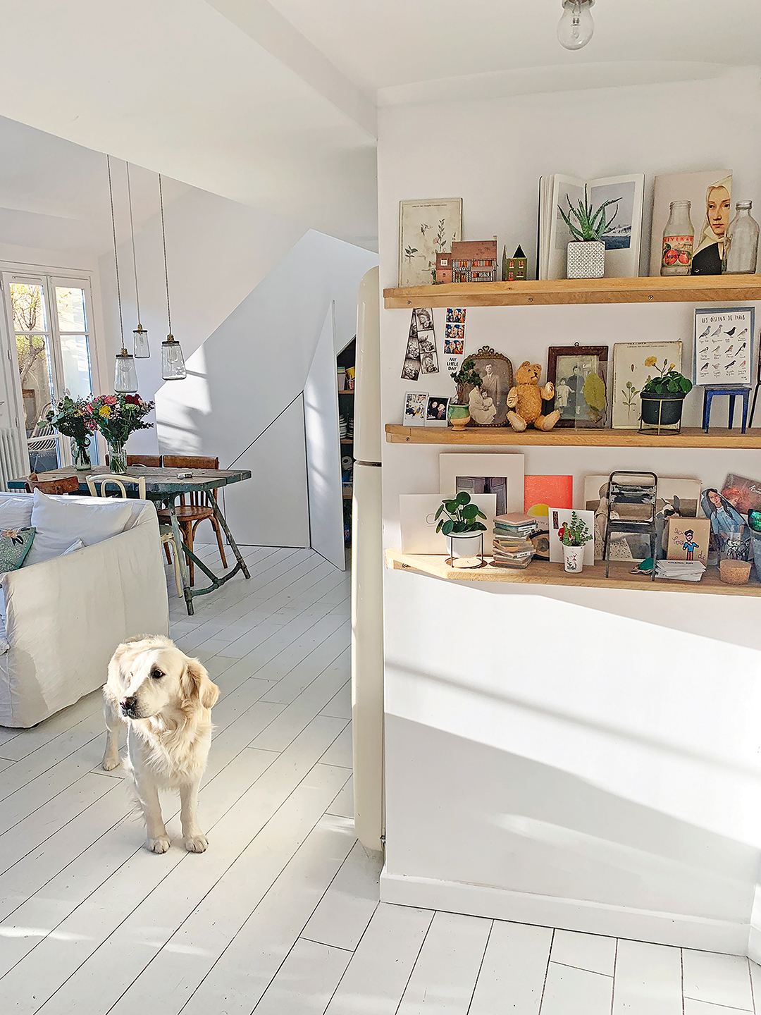 Whitewashed living and dining area with white painted floors