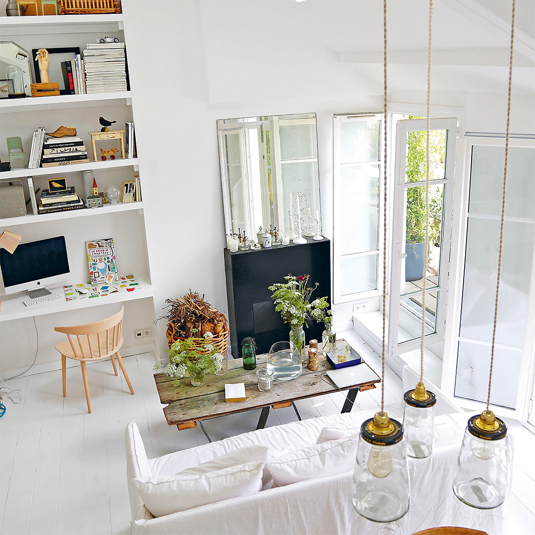 Whitewashed living room with black metal fireplace
