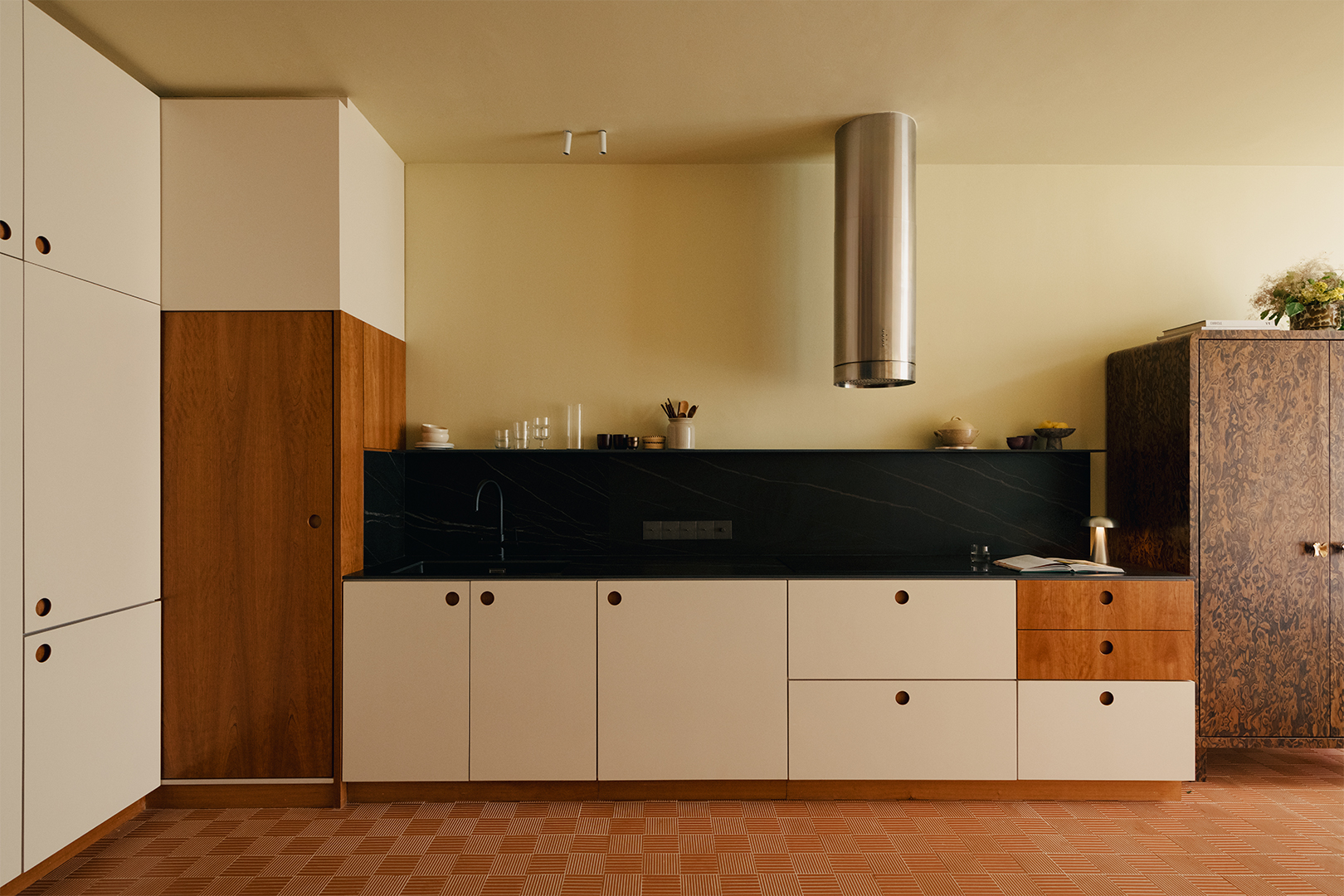 Modern kitchen with stone backsplash and white and wood cabinetry 