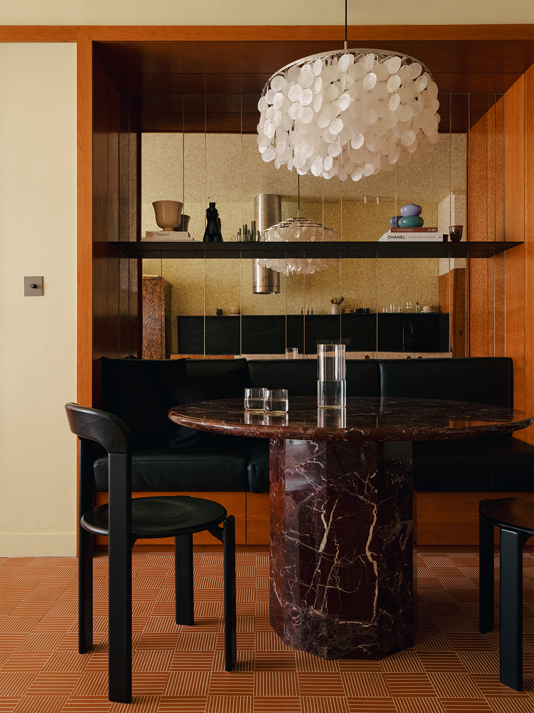 Banquette seating and mirrored wall in the dining nook