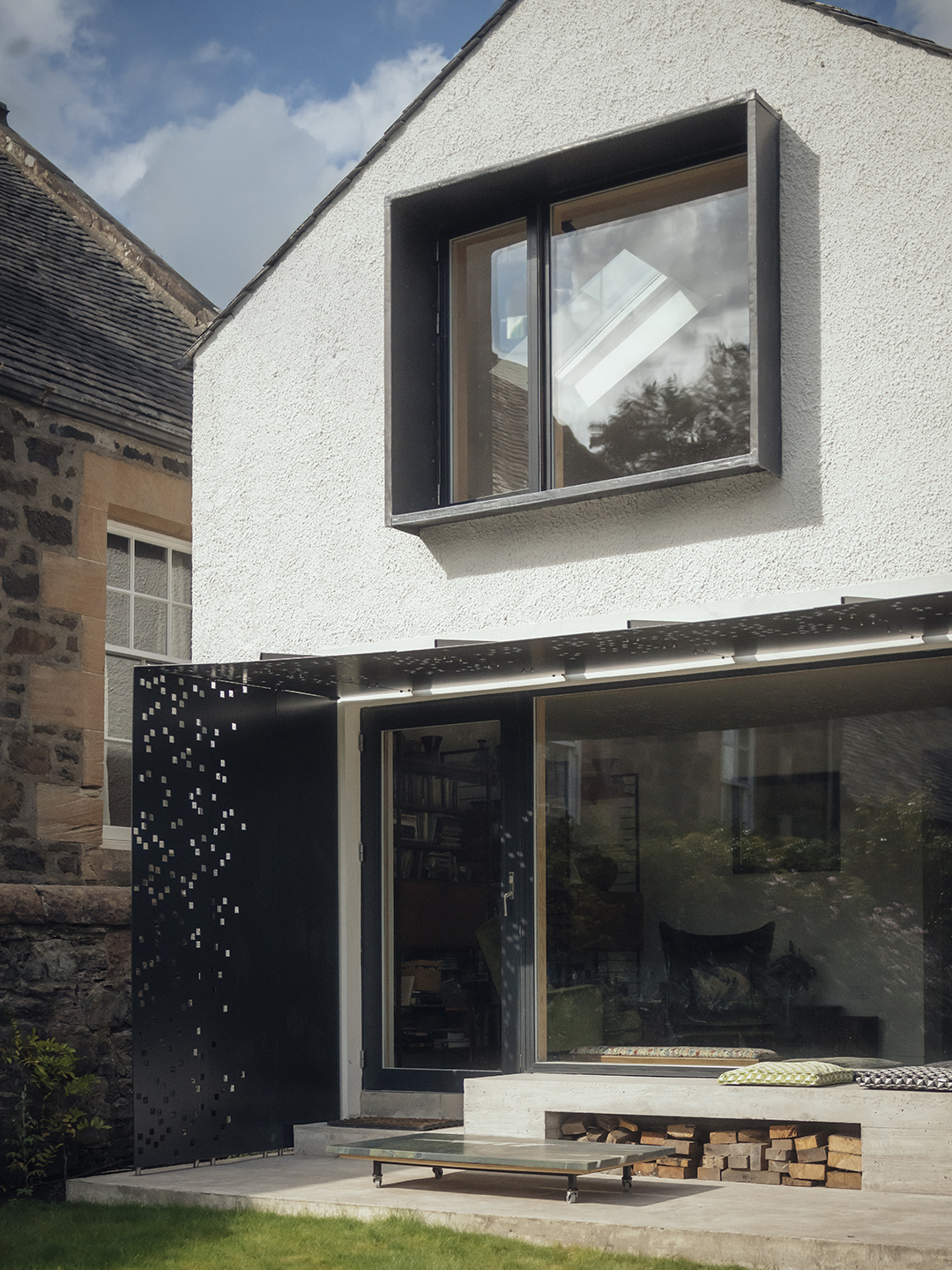 cottage with black metal canopy