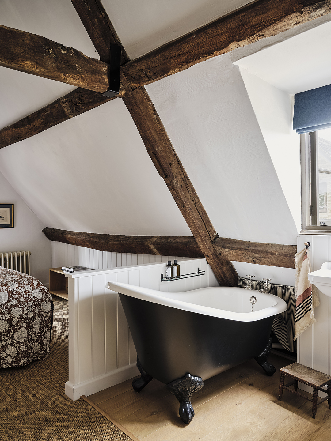 Black cast-iron tub in bedroom