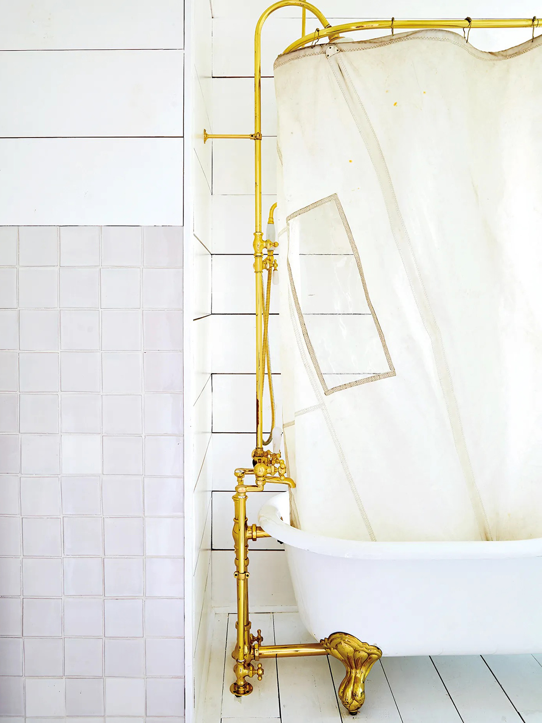White cast-iron tub in white bathroom