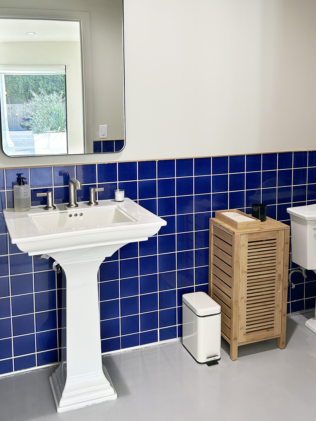 Half bath with blue tile half wall