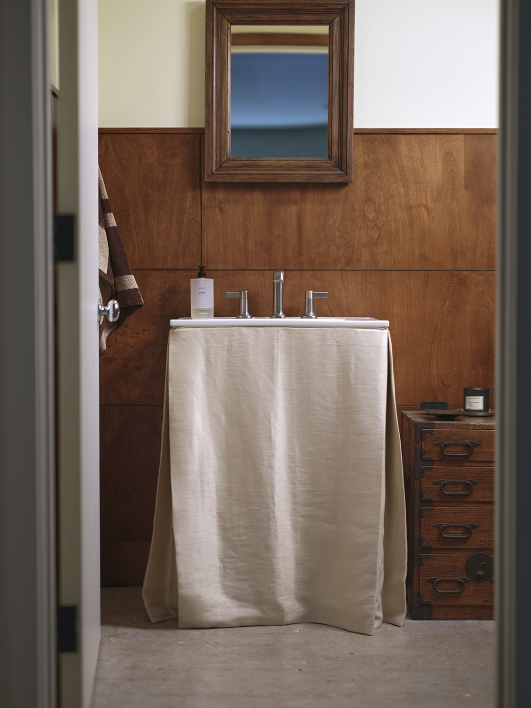 Half bath with wood paneling 
