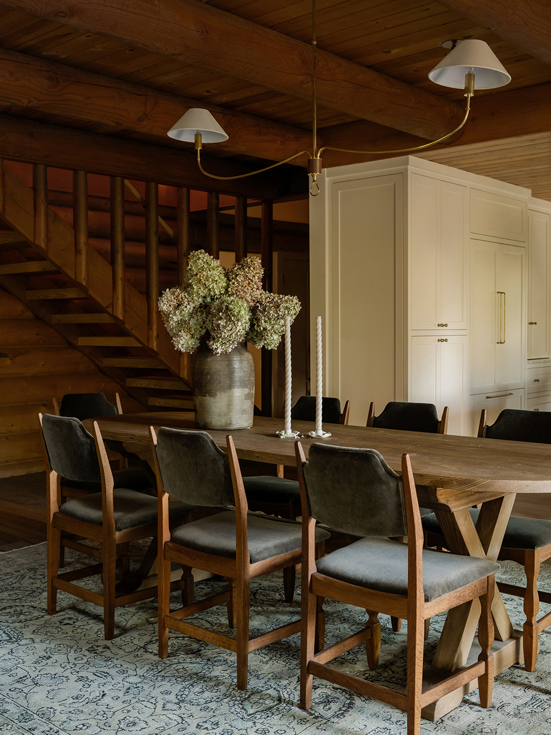 Dining room with green rug and wooden dining table and chairs