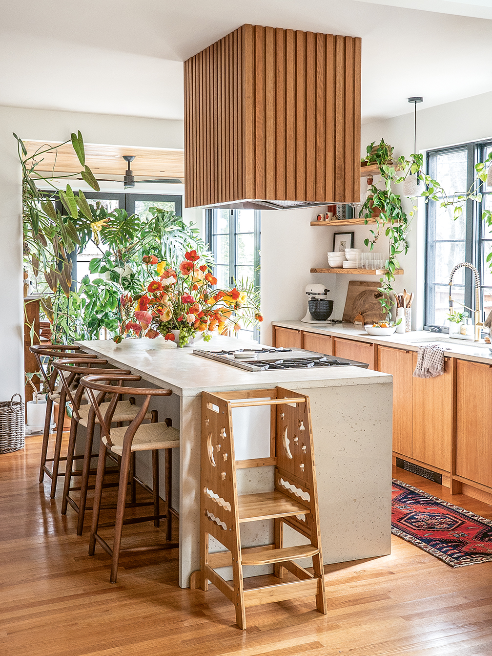 Stone kitchen island and wood cabinets