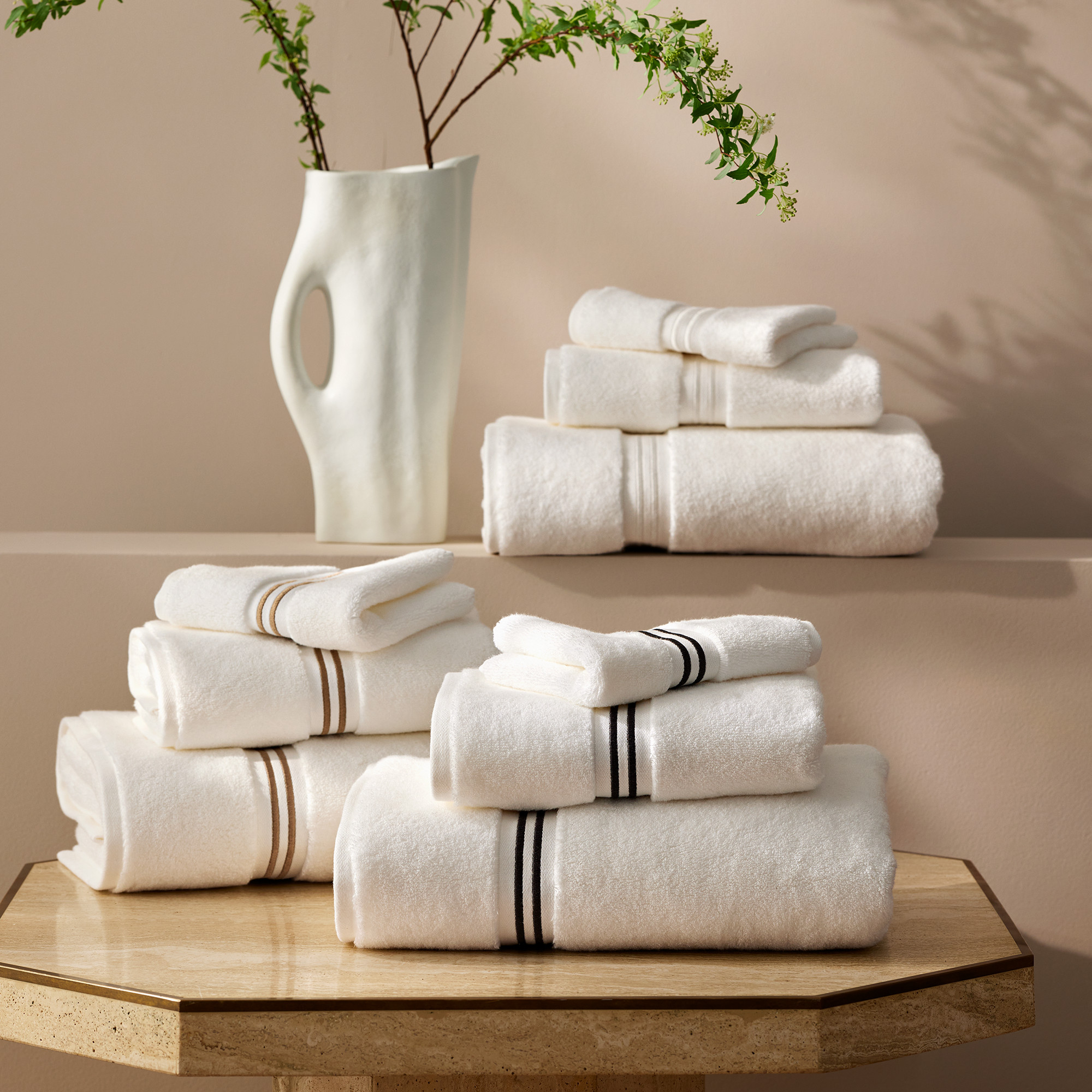 Three piles of neatly folded white towels.