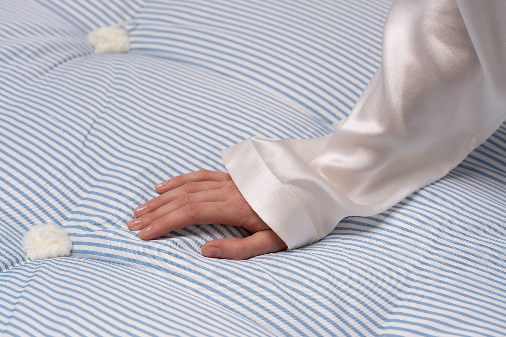 hand touching mattress