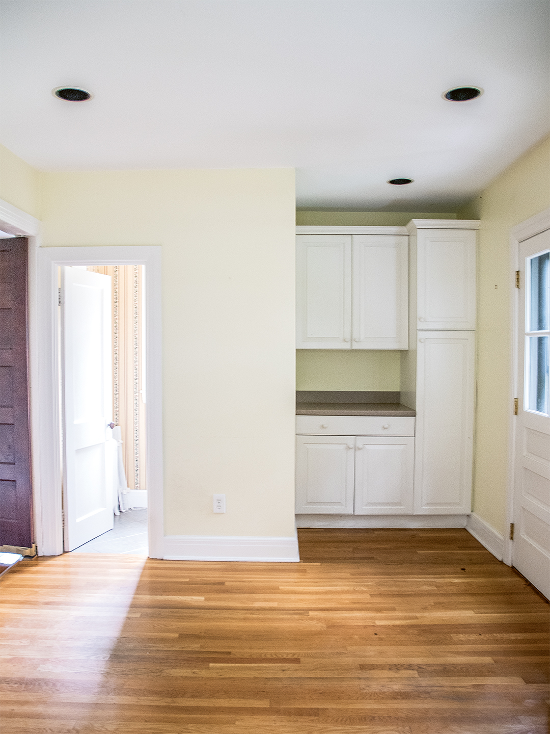 White kitchen cabinets and yellow walls