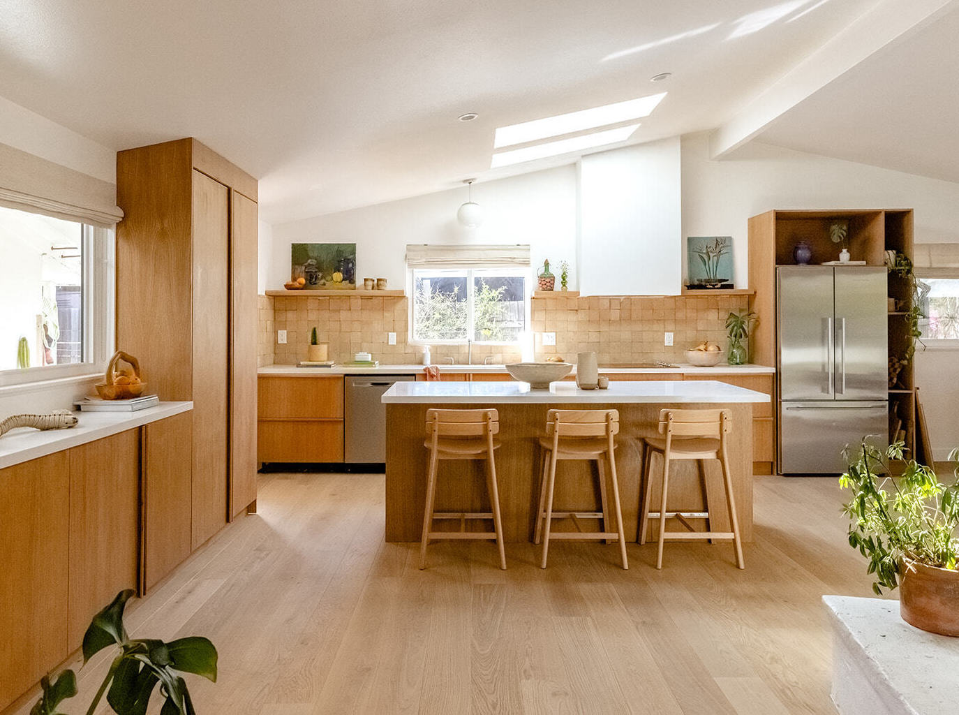 Kitchen with skylights, wood cabinets, and brown tile.