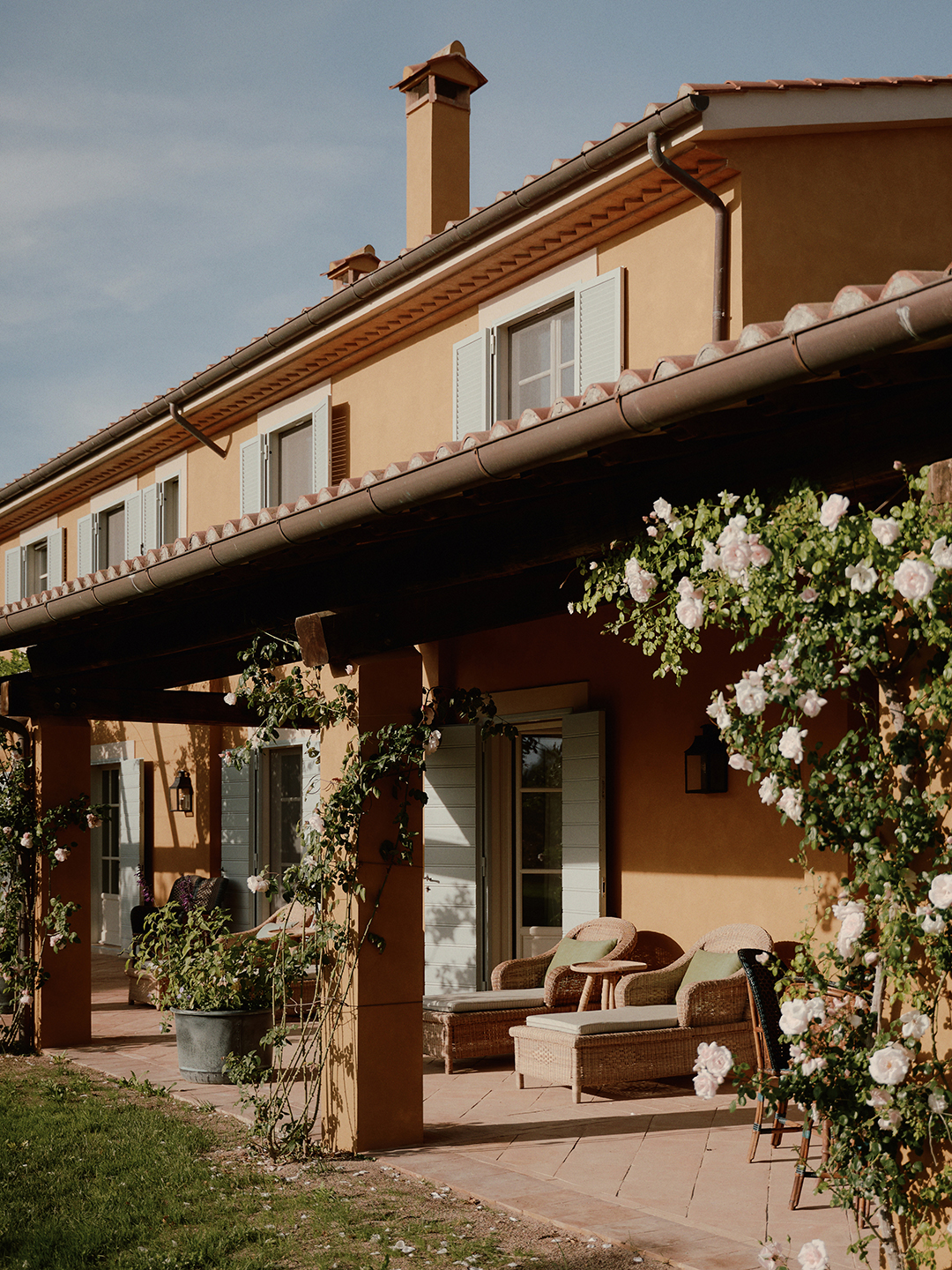 Exterior of a villa with rattan loungers on a patio