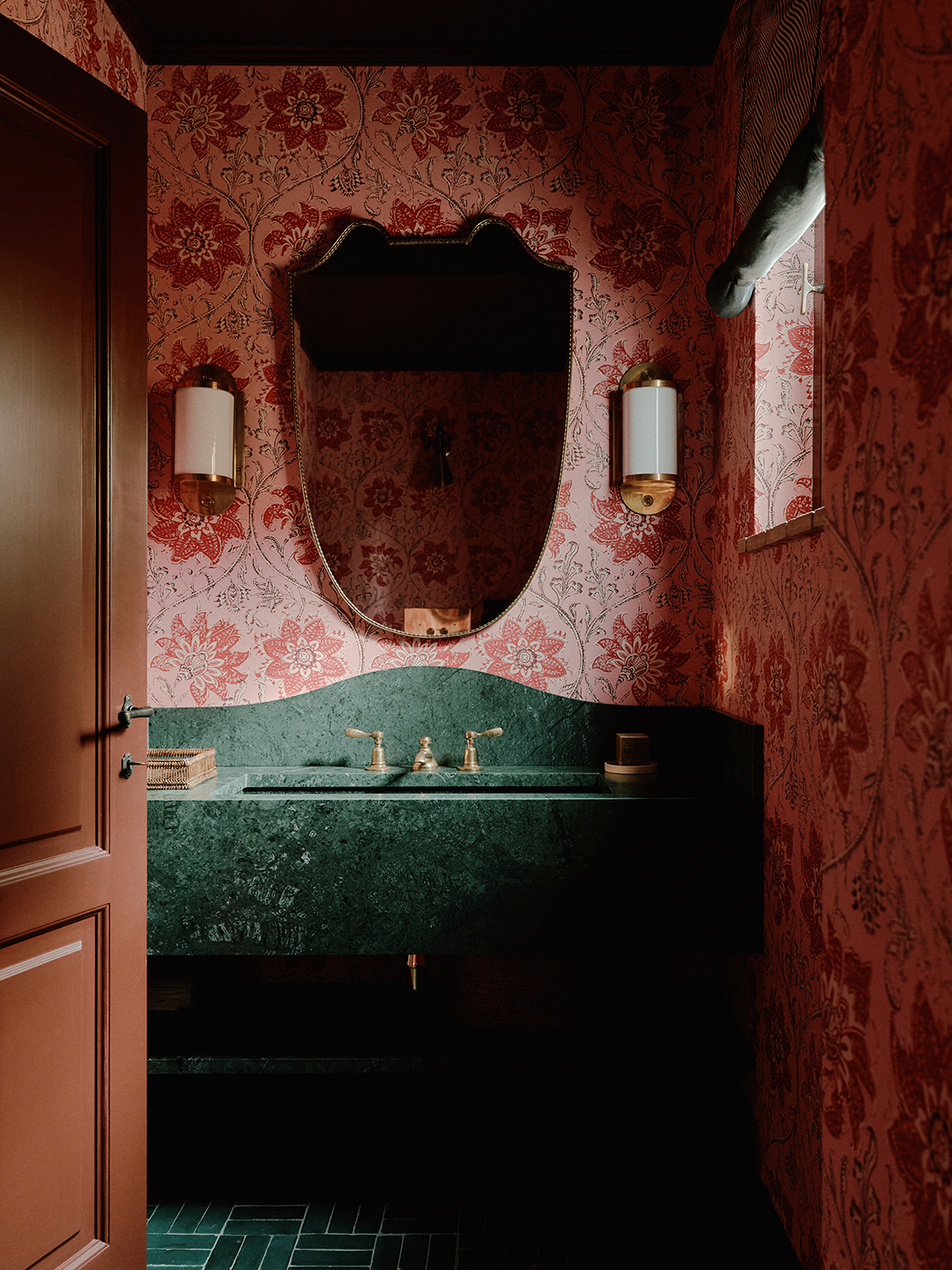 Floral wallpapered powder room with green marble vanity