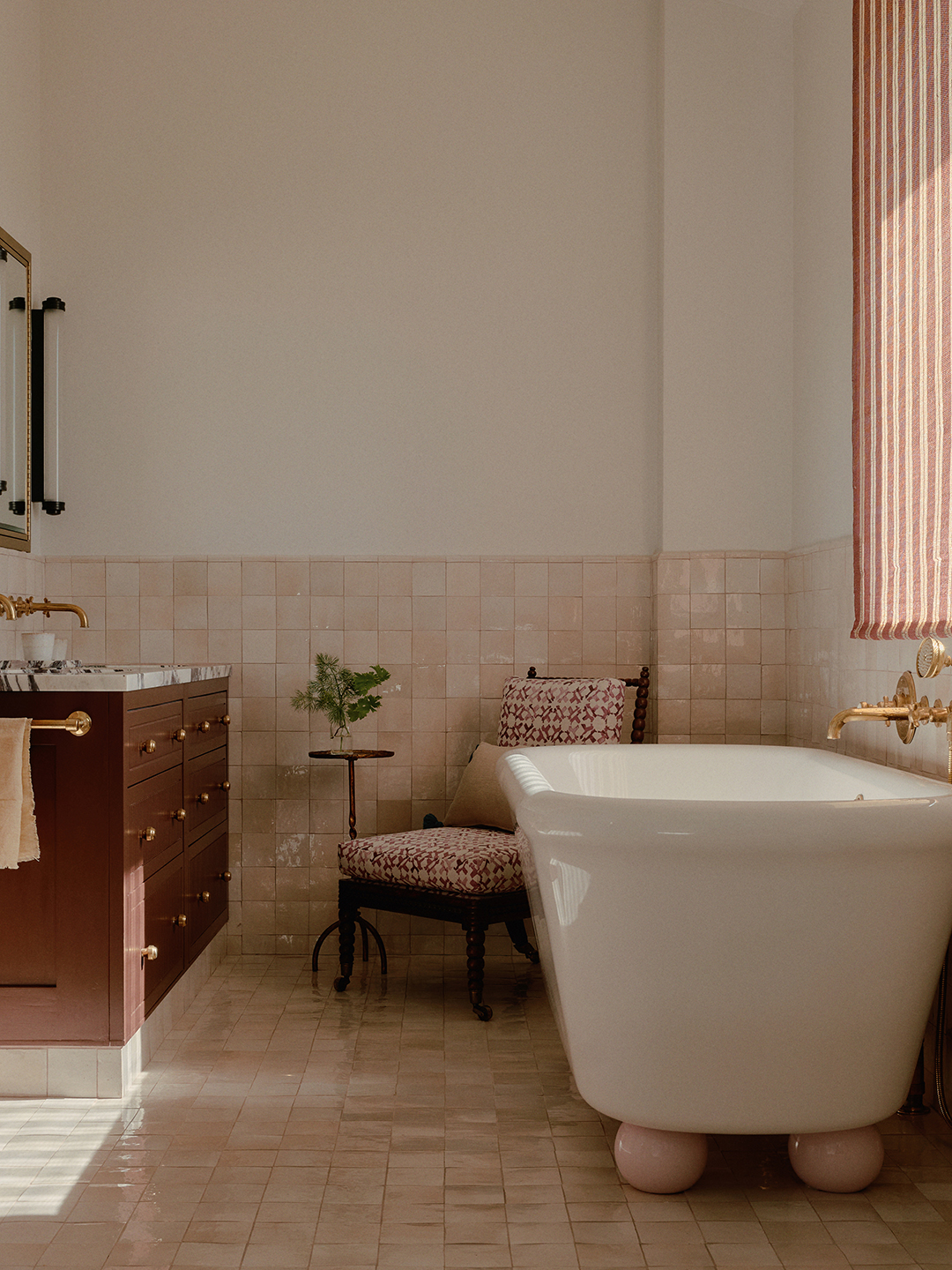 Primary bathroom with zellige tile floors and walls and white soaking tub