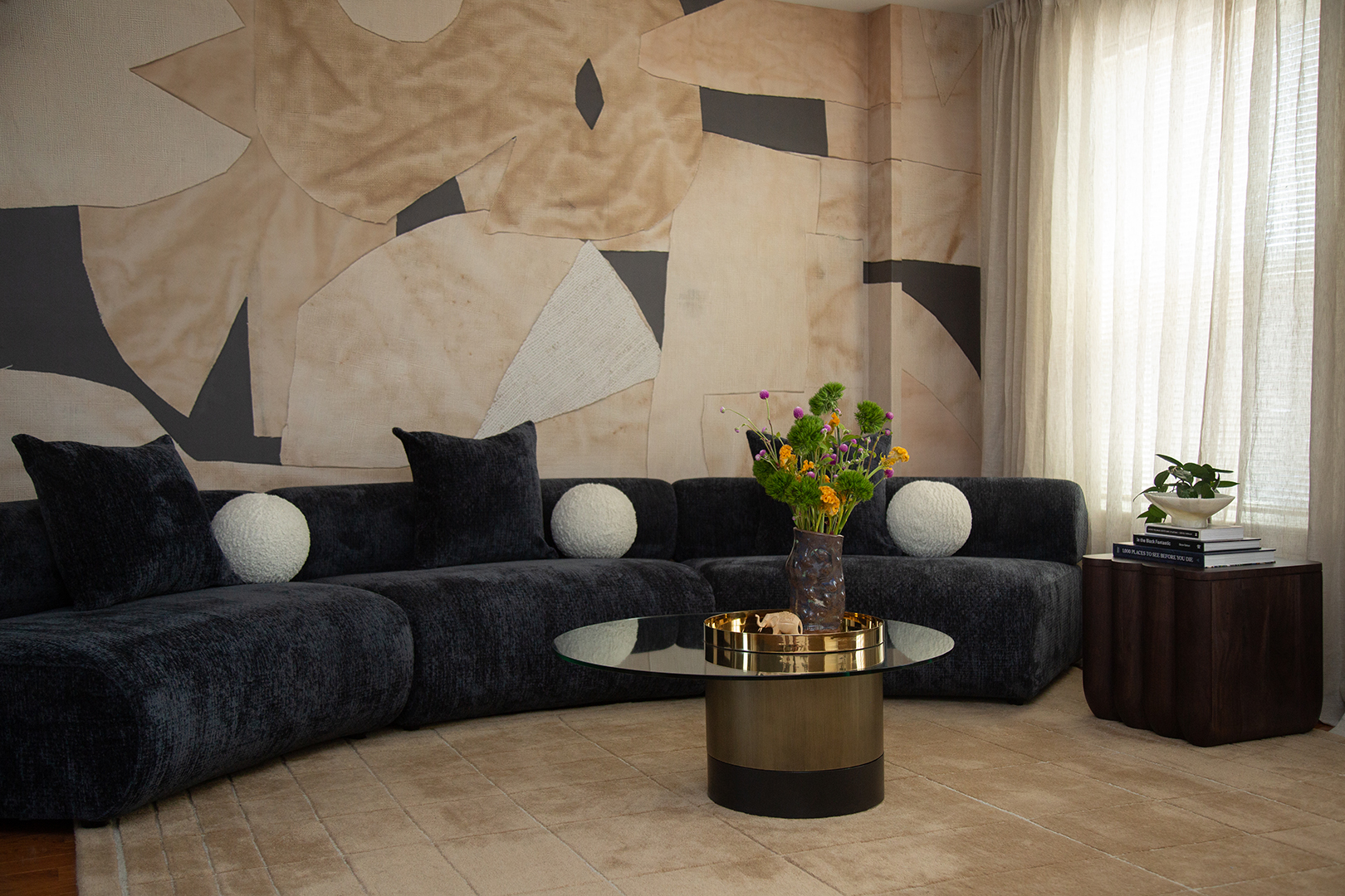 curved sofa with accent wallpaper