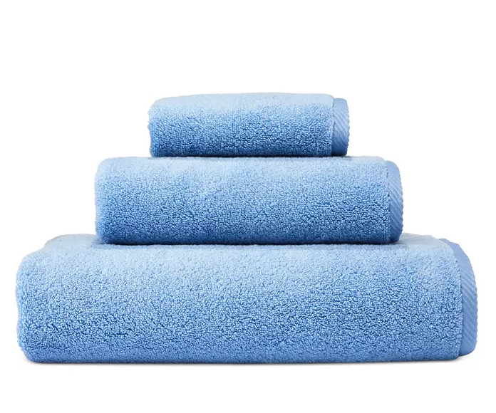  Stack of three blue towels against white background.