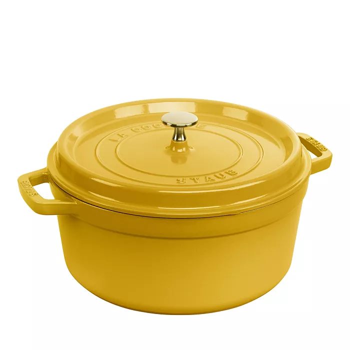  Yellow Staub Dutch oven on white background.