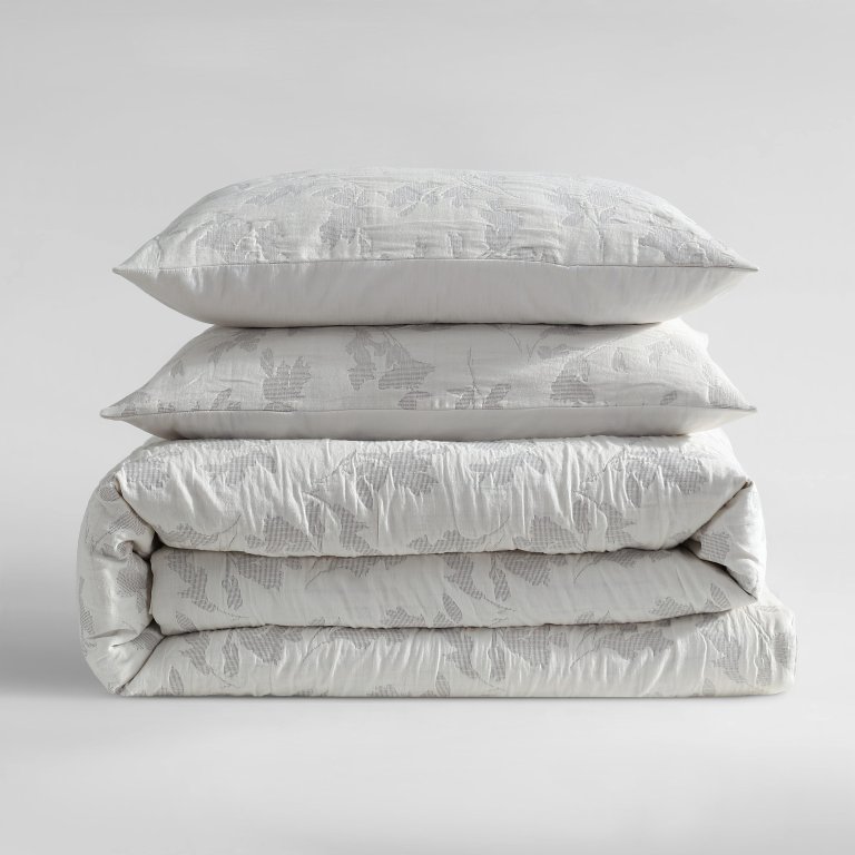  Folded stack of white duvet set bedding.