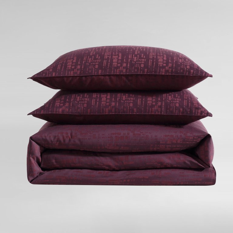  Stack of burgundy-hued bedding.