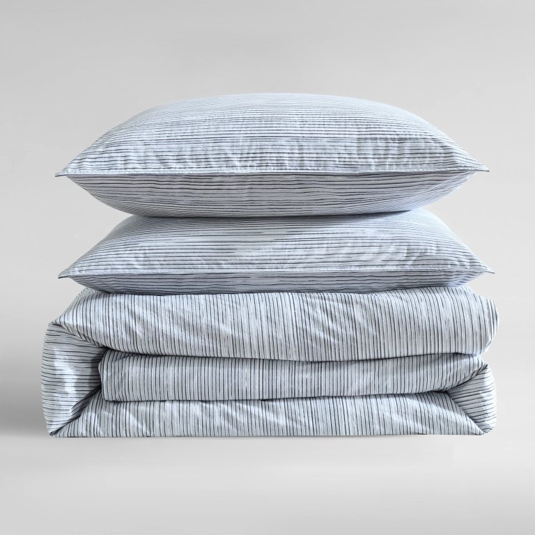  Stack of striped blue and white bedding.