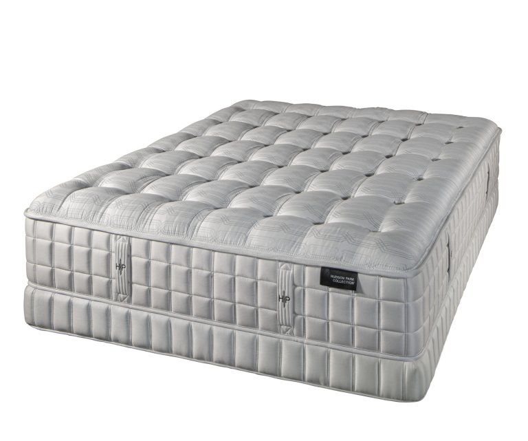  Grey tufted mattress against white background.