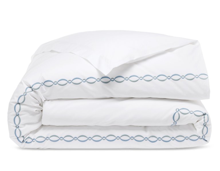  White sheets with blue chain link embroidered border.