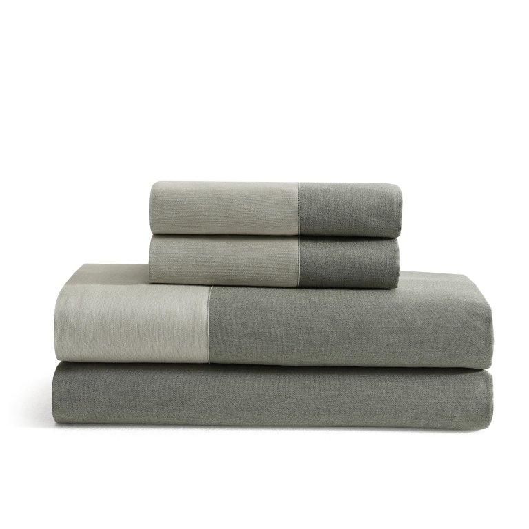  Stack of folded sage green bedding.