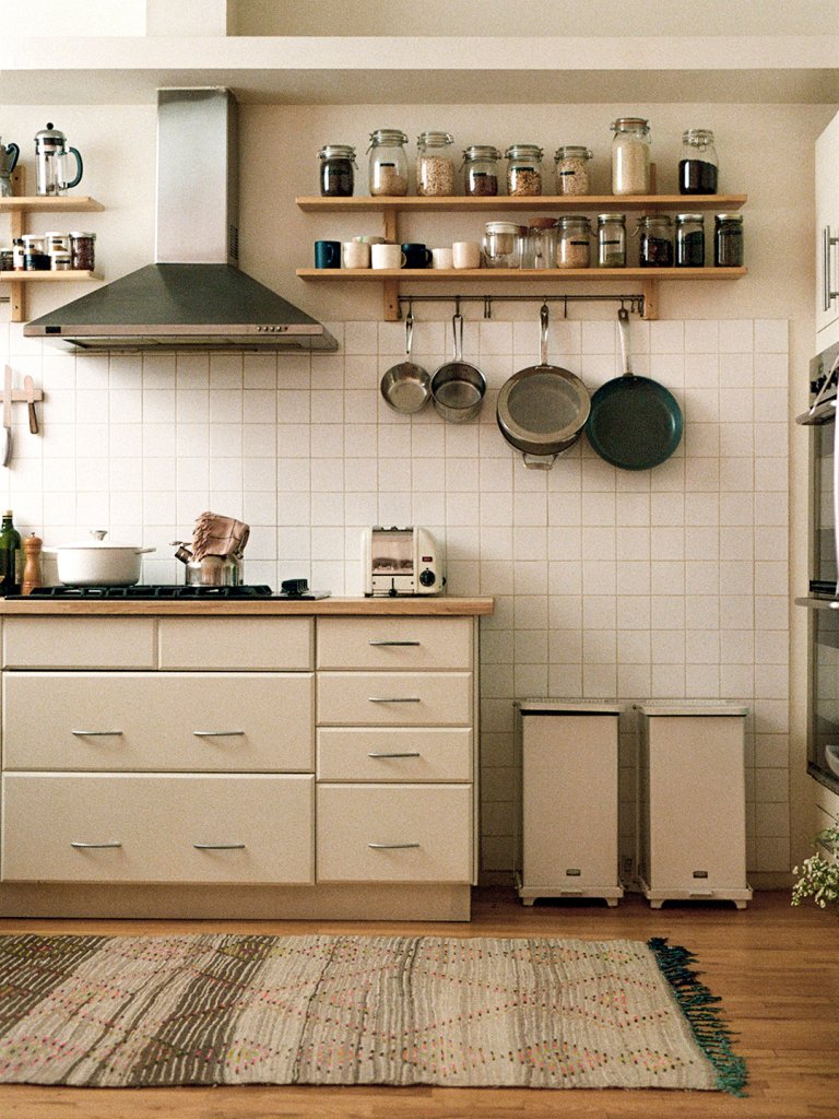 white kitchen with two side-by-side trash cans