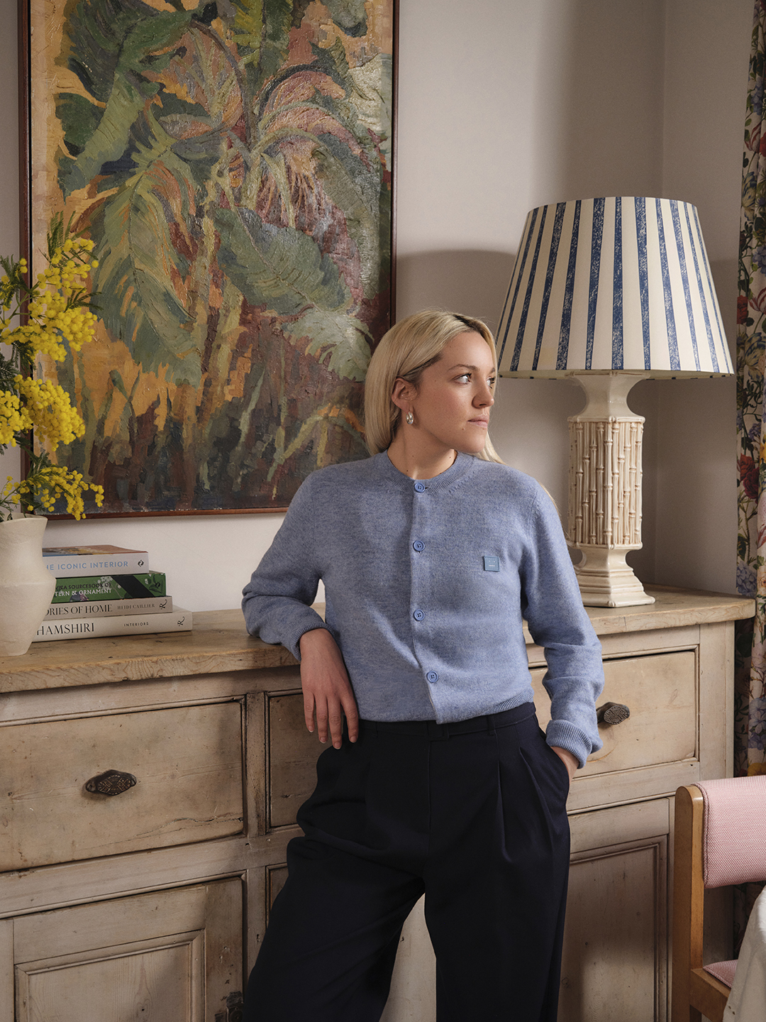woman leaning on dresser