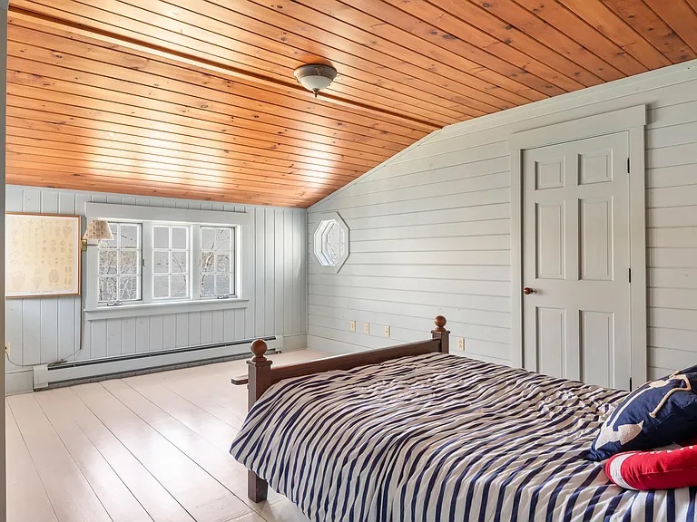 bedroom with angled ceiling