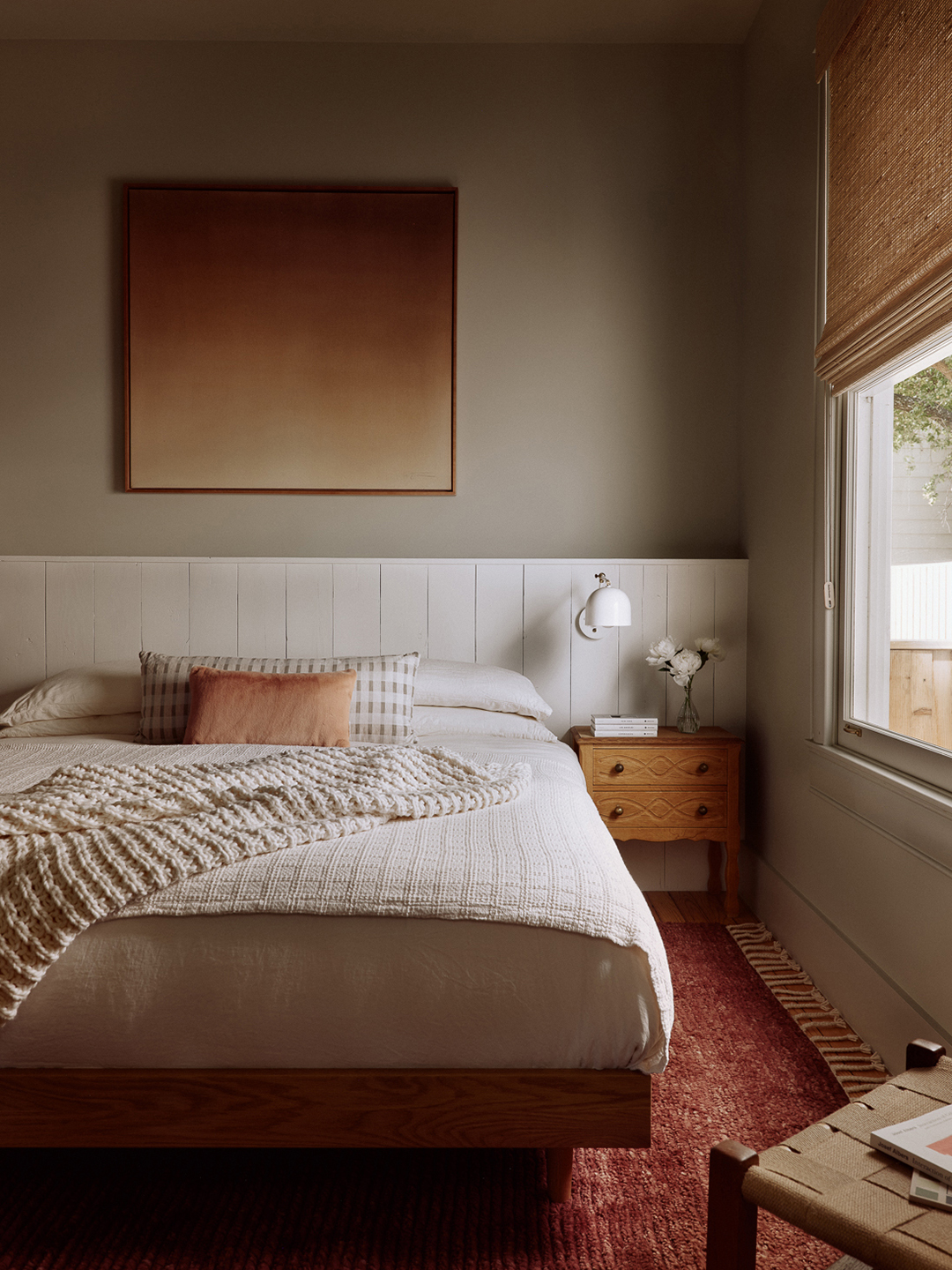 gray bedroom with red rug