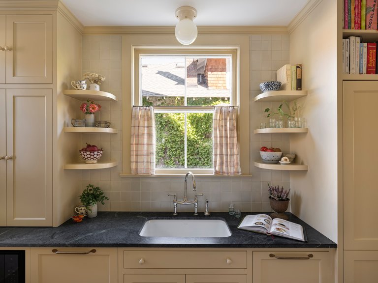 kitchen sink area with curved open shelving