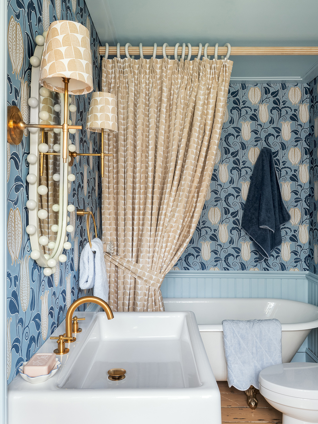 bathroom with wallpaper and tall curtain