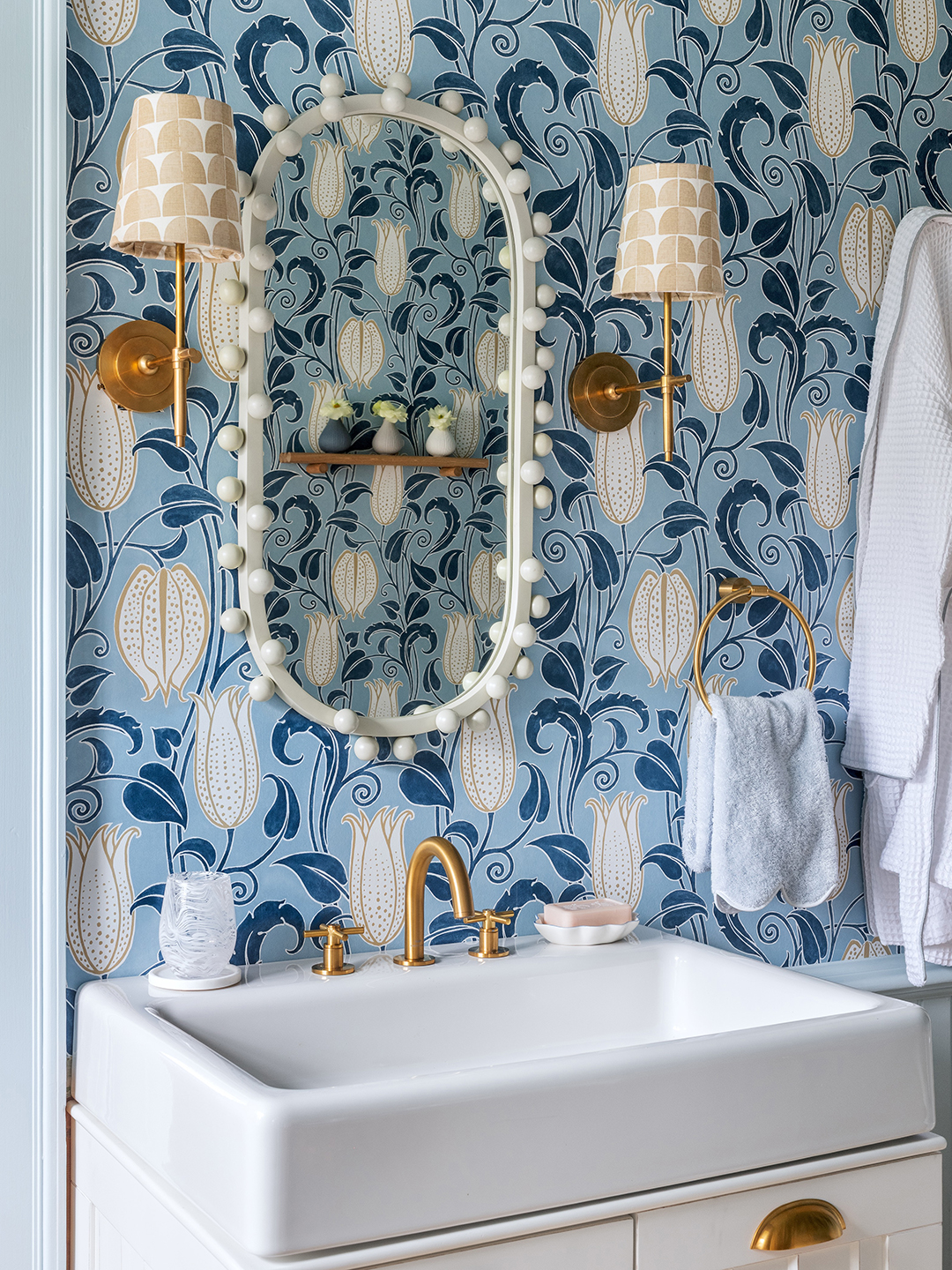 bathroom sink with blue patterned wallpaper