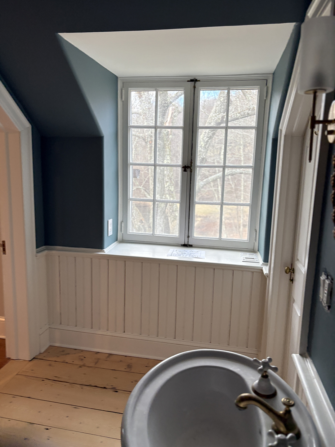 angled wall beside a large window