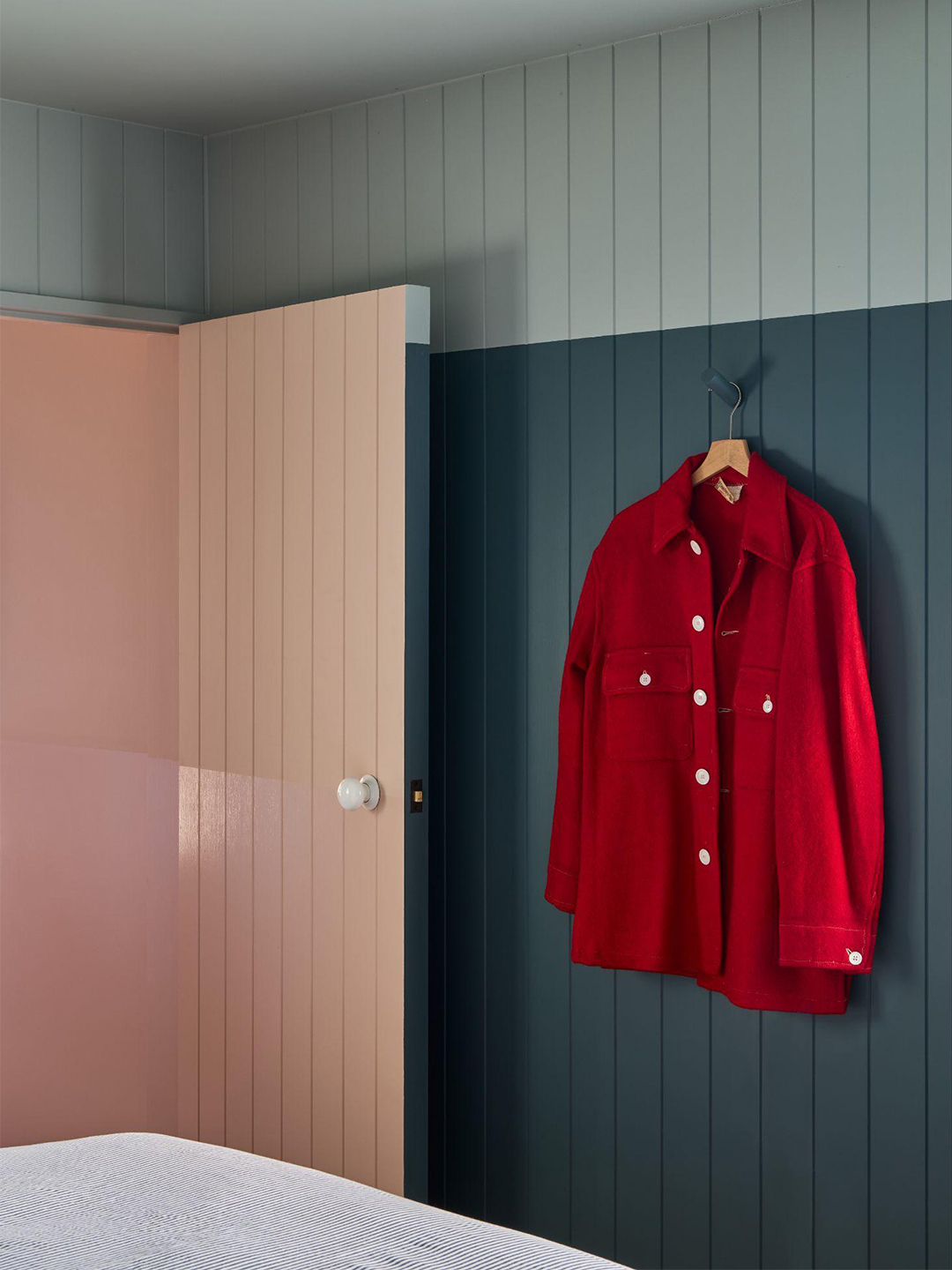 red shirt hanging on blue wall
