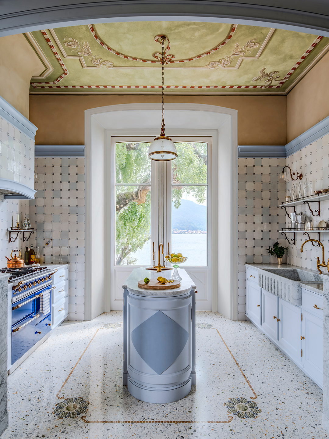 blue kitchen with small island in the middle