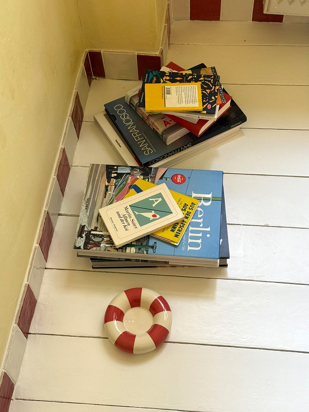 tiled baseboard next to stacks of books