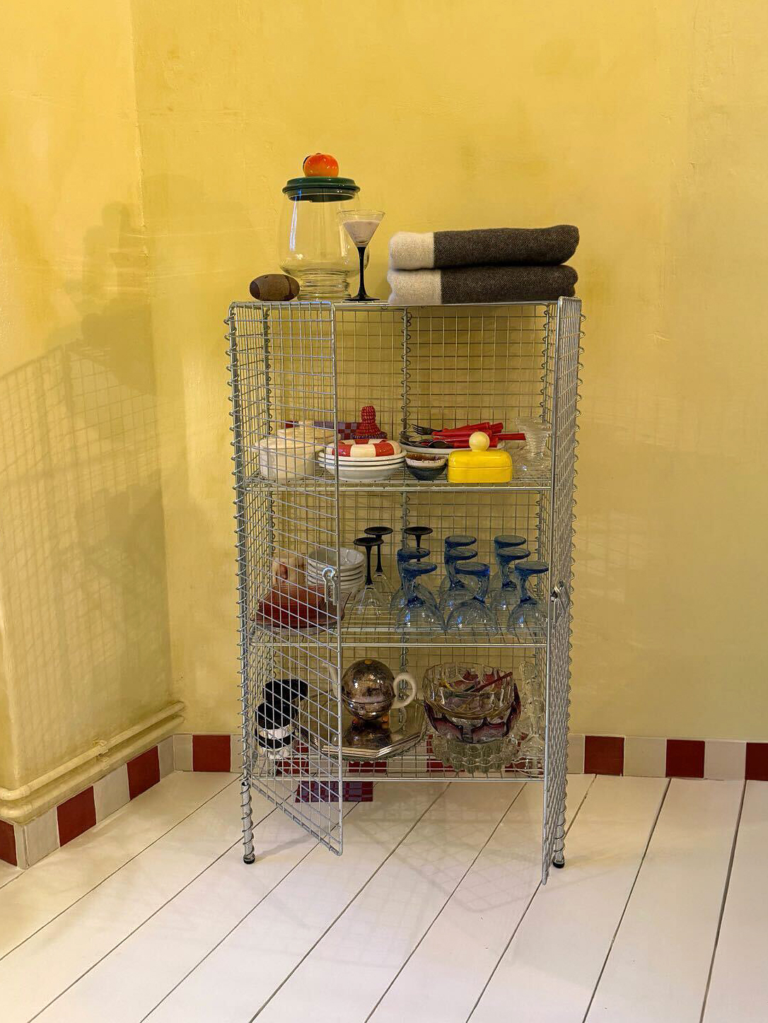 yellow room with red and white tile baseboard