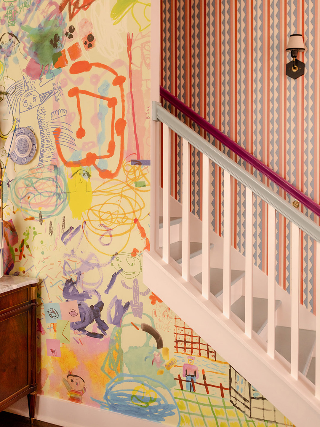 kids art scribbles on wall near stairs