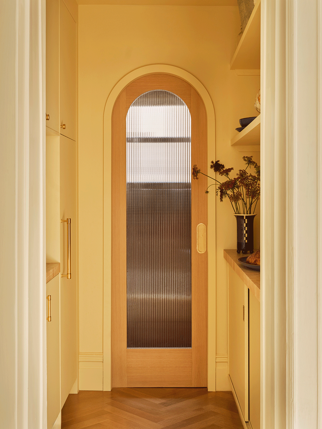 gif of a yellow room with an arched door that opens and closes