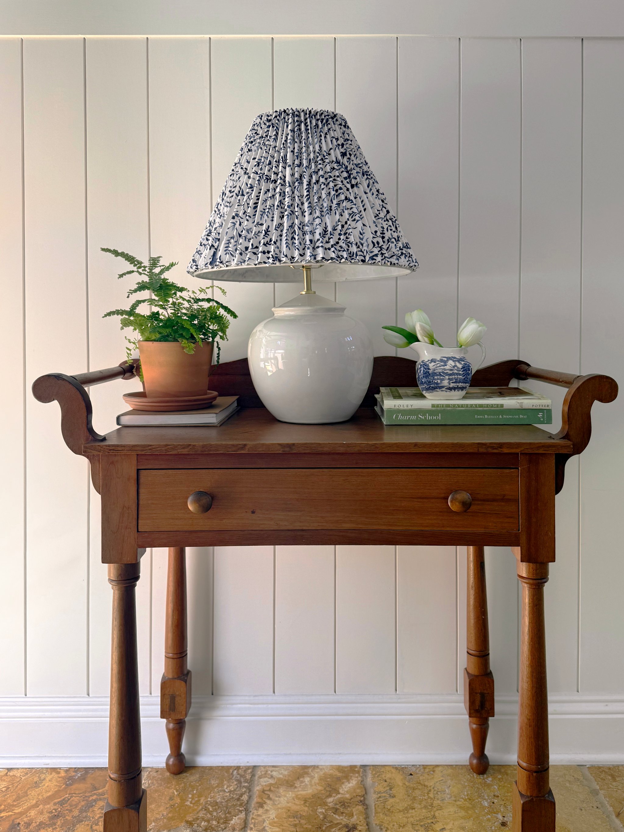 lamp with pleated floral shade on a side table