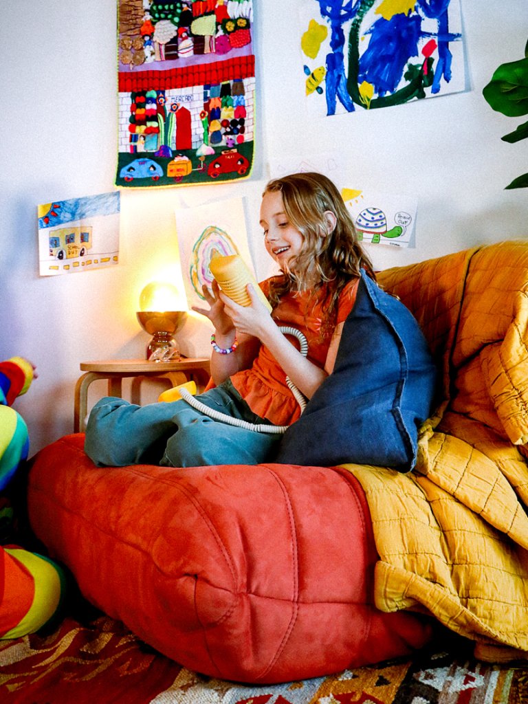 child using a yellow landline phone