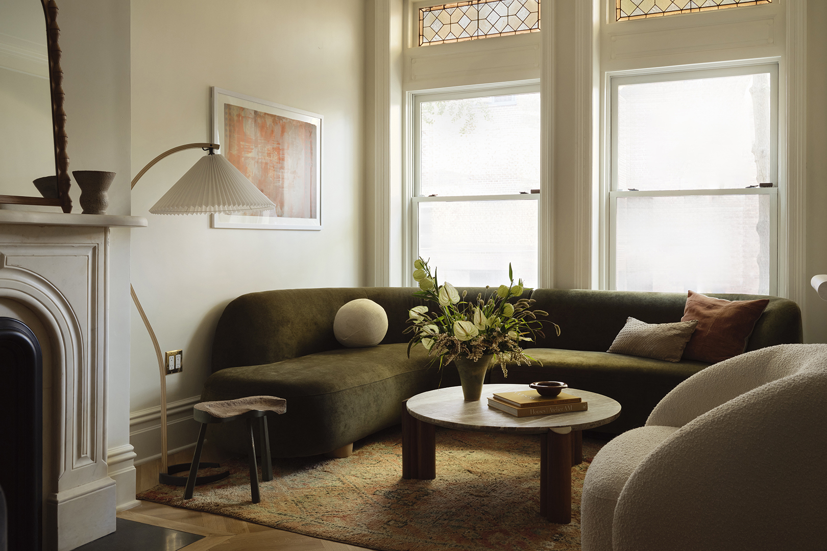 cream living room with green curved sofa