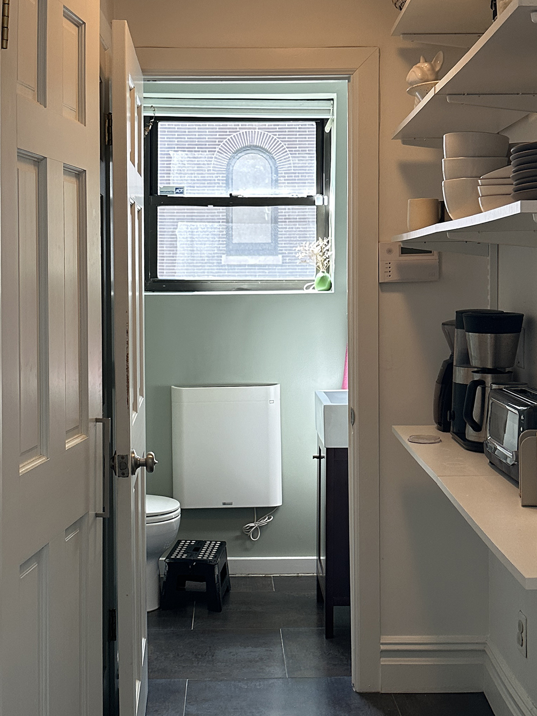 dark white hallway leading to bathroom