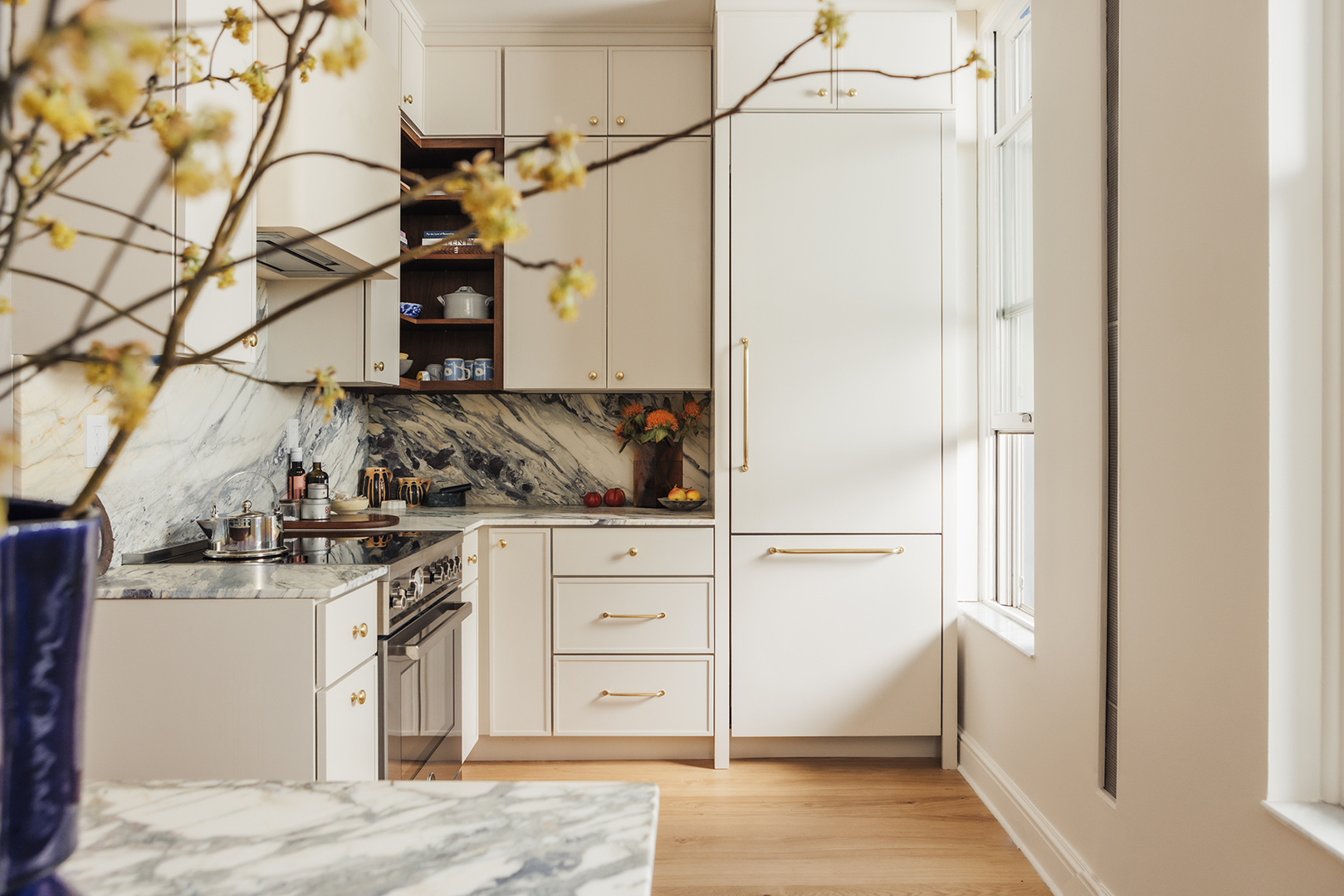 kitchen with white cabinetry and marble backsplash