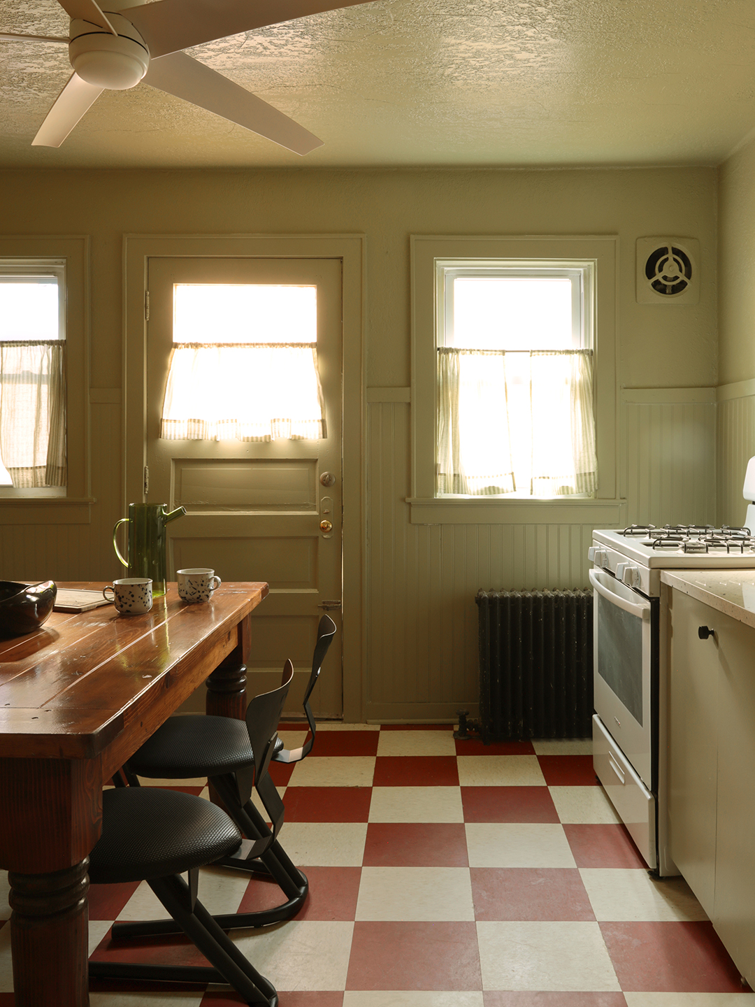 sage green kitchen with checkered floors