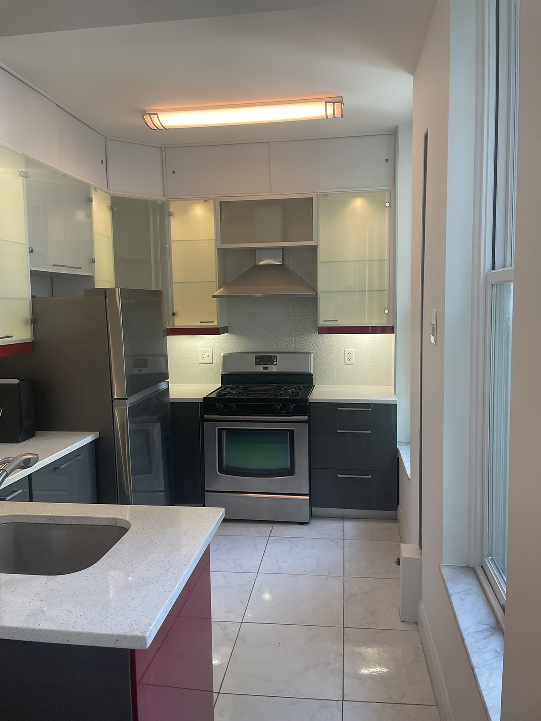 kitchen with white countertops, cabinets, and grey accents