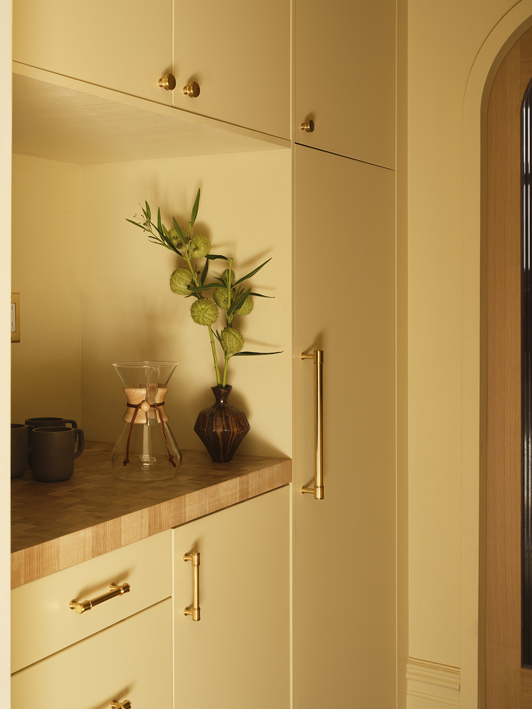 wall of yellow built-in cabinetry with countertop